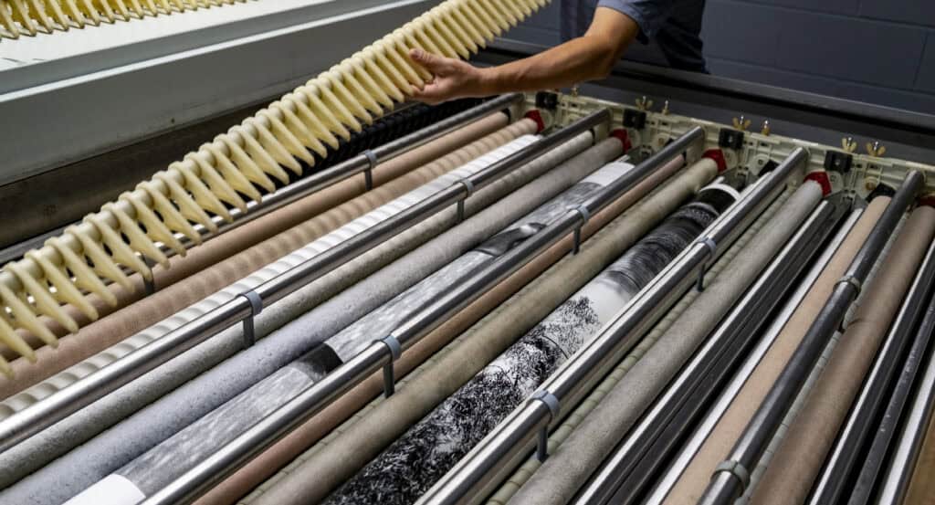 C-print Tech guiding the Silver Gelatin print through the processor rollers